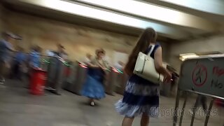 Ut_6058# Under the skirt of a girl in a loose white and blue dress. Her pubic area and shaved