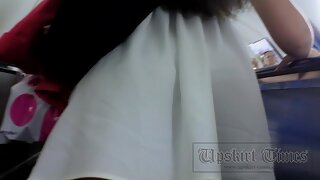 UT_2324#Well-tanned brunette girlie in short white dress. The cameraman was holding her skirt