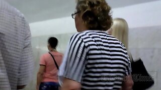 UT_3029#Blonde in a wide striped dress. On the escalator in the subway you can find different